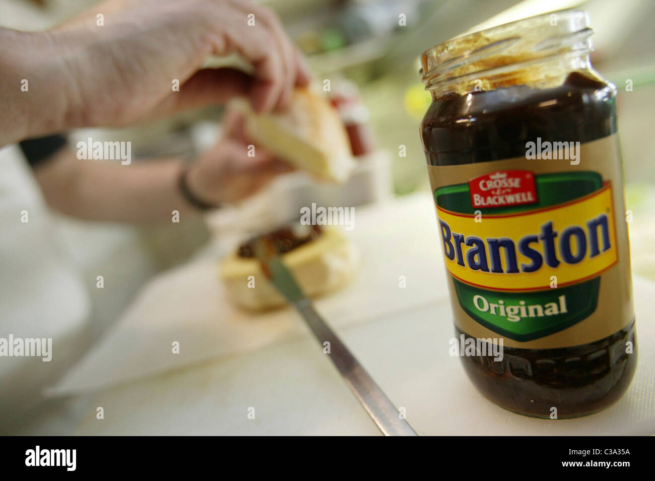 A man making a sandwich using Branston Original Pickle; a Premier Foods