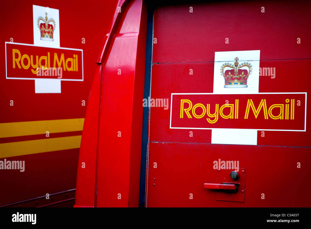 Royal Mail delivery lorries and minivans parked in the car park of the