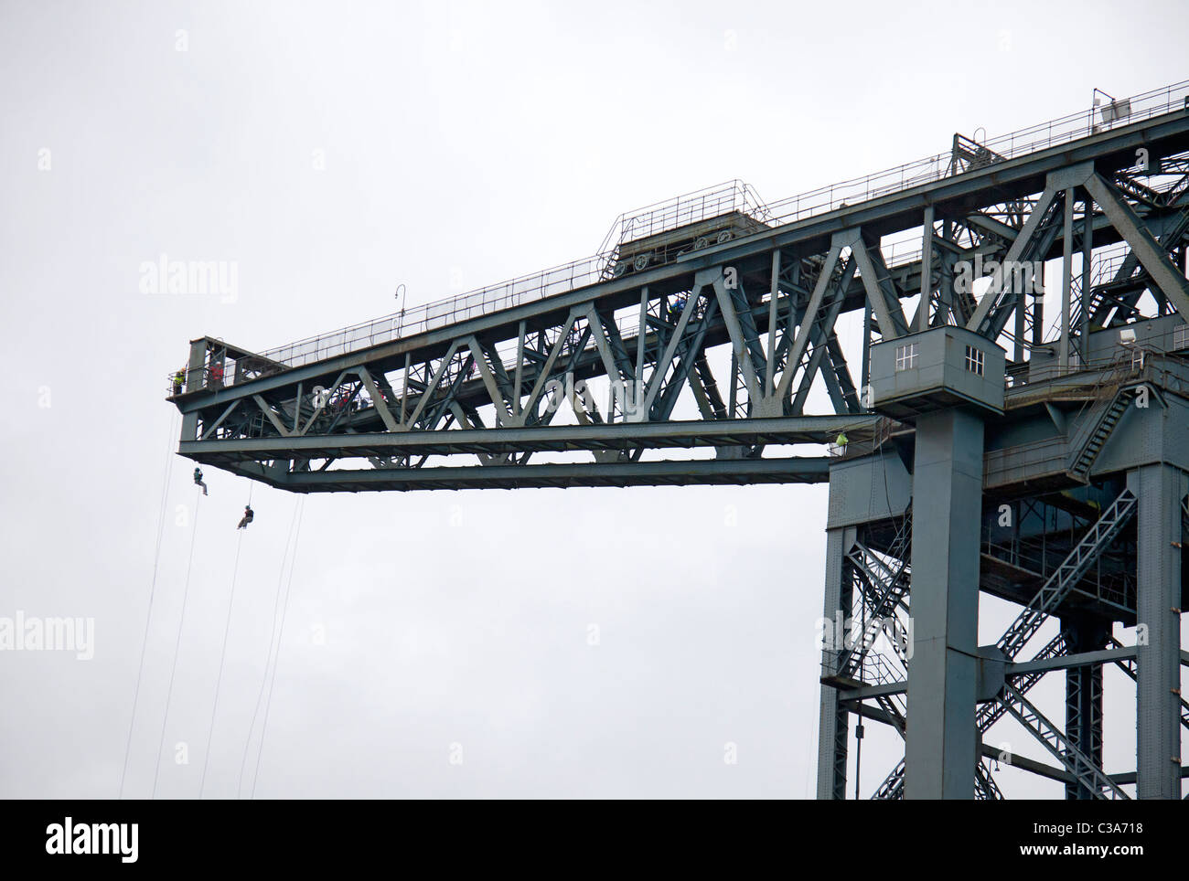 Two people complete a charity abseil from the Finnieston Crane, Stobcross Glasgow. Scotland, UK. Stock Photo