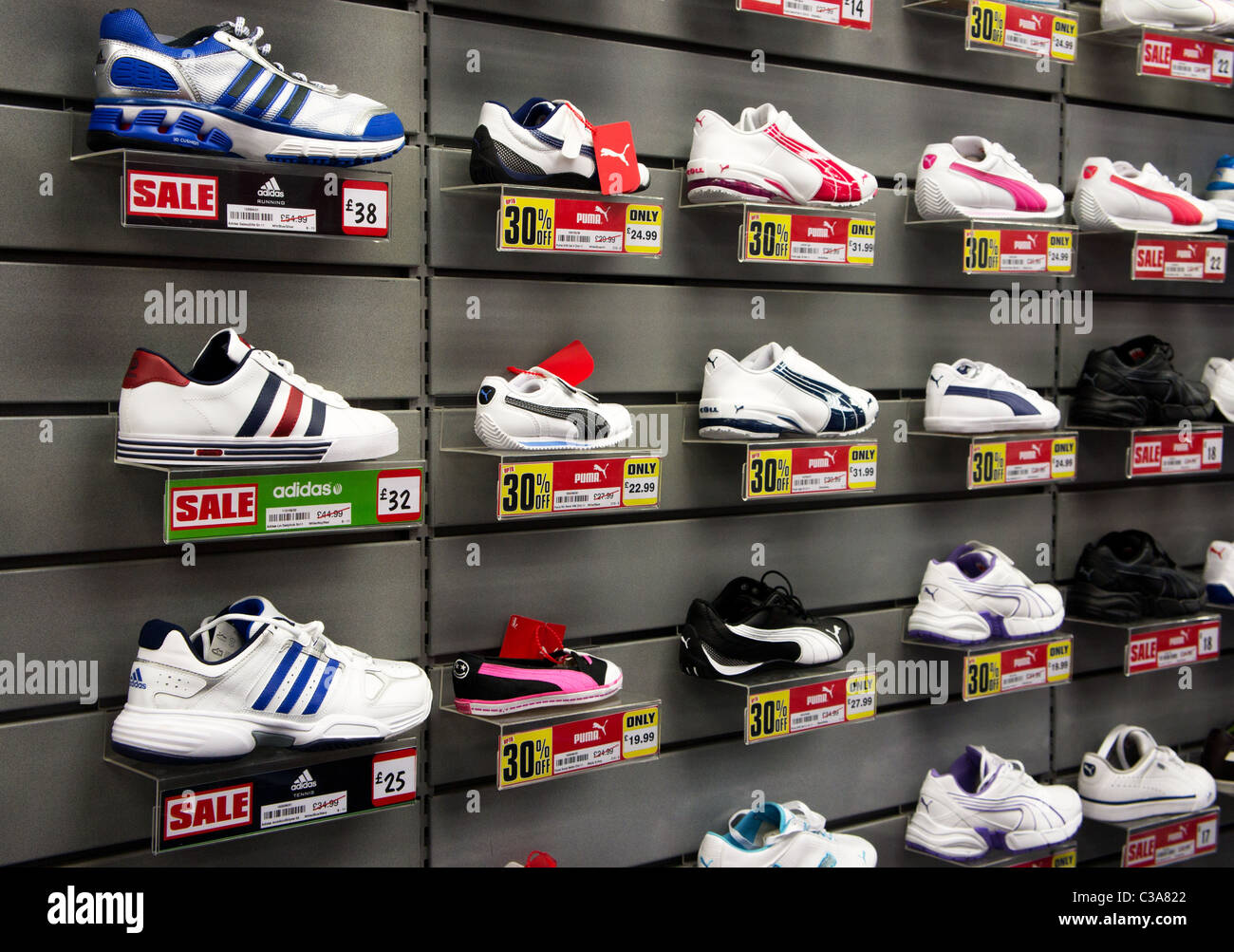 Running shoes on sale in a sporting goods store, uk Stock Photo