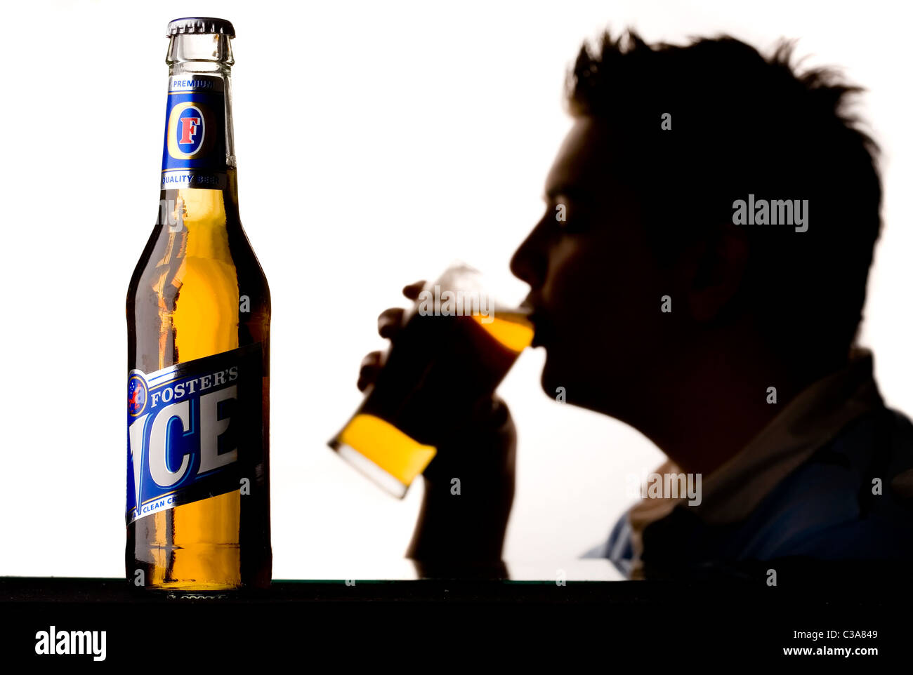 A man enjoying a pint of Fosters Ice beer Stock Photo Alamy