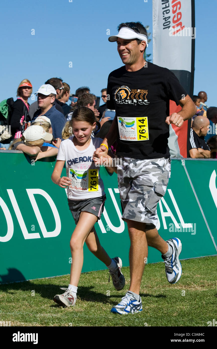 Father and daughter finishing the 5km Fun Run, Two Oceans Marathon, Cape Town, South Africa Stock Photo