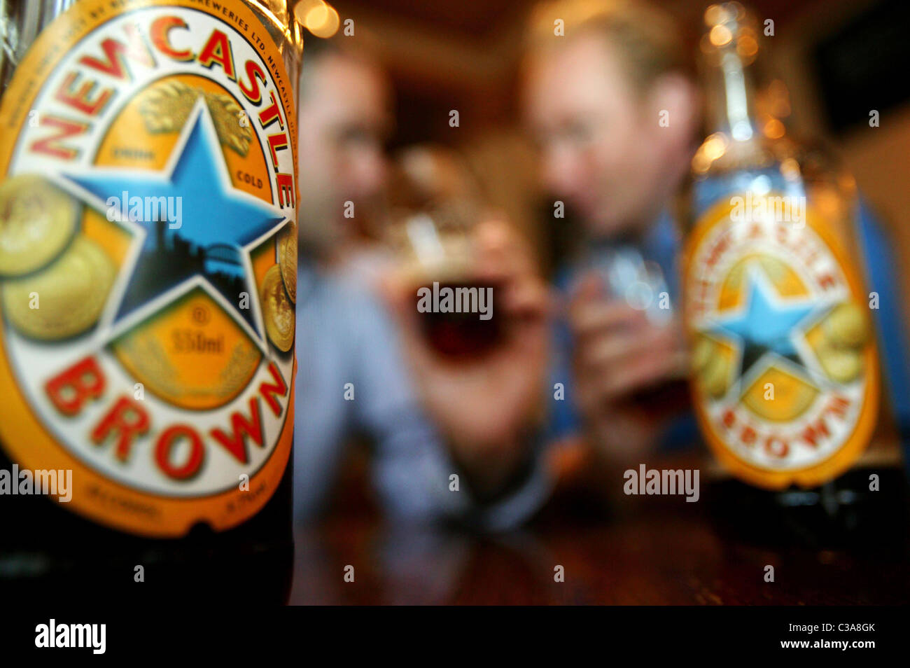 Two men drinking Newcastle Brown Ale; a Scottish and Newcastle brand