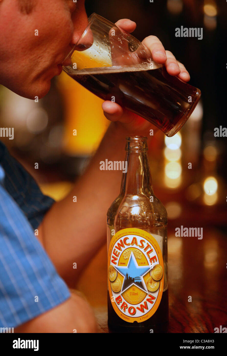 A man drinking Newcastle Brown Ale a Scottish and Newcastle brand