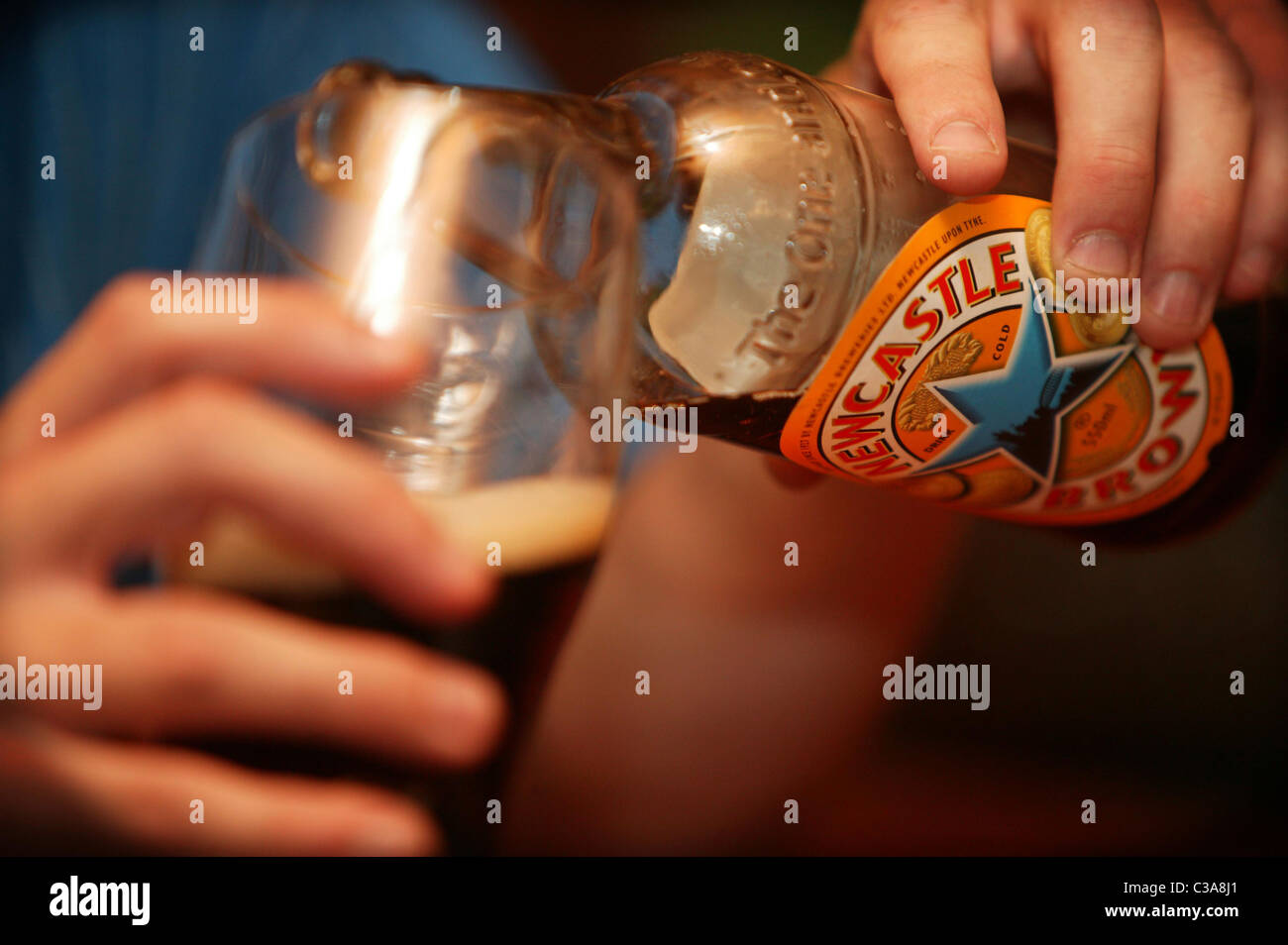 A man drinking Newcastle Brown Ale a Scottish and Newcastle brand