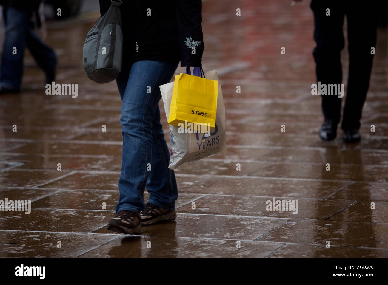 A Selfridges customer walking along London's Oxford Street with their
