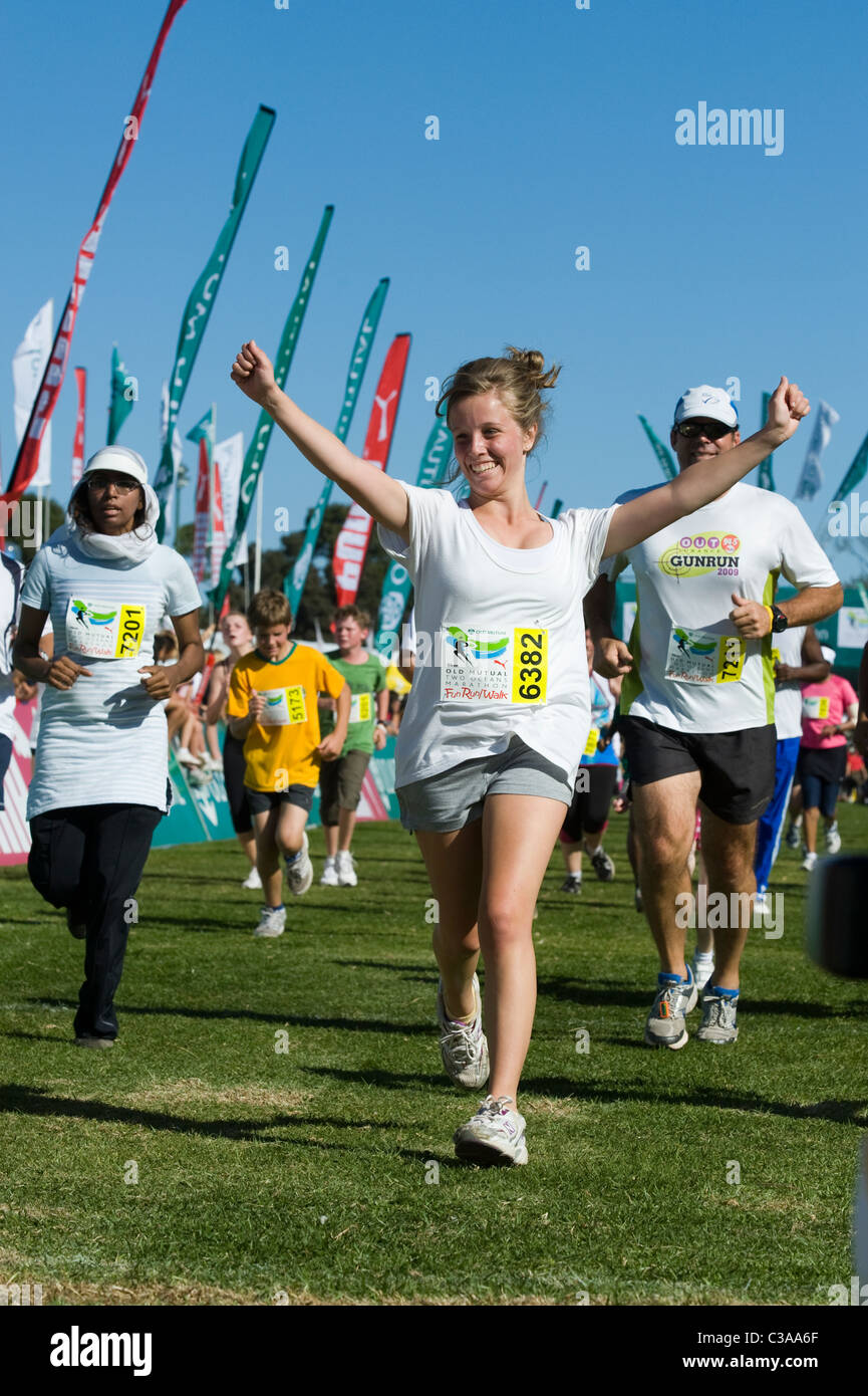 Runner celebrates at the finish of the 5km Fun Run, Two Oceans Marathon