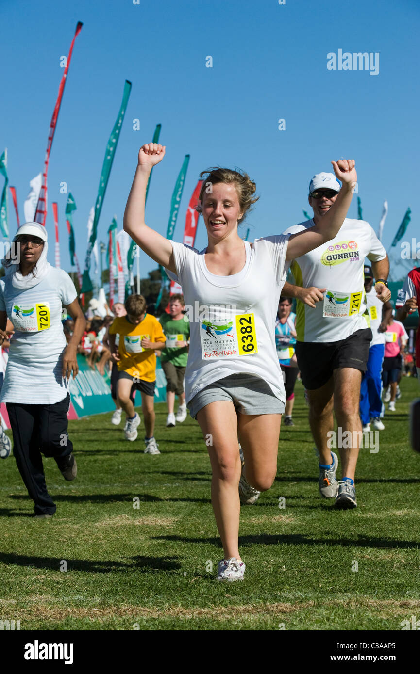 Runner celebrates at the finish of the 5km Fun Run, Two Oceans Marathon, Cape Town, South Africa Stock Photo