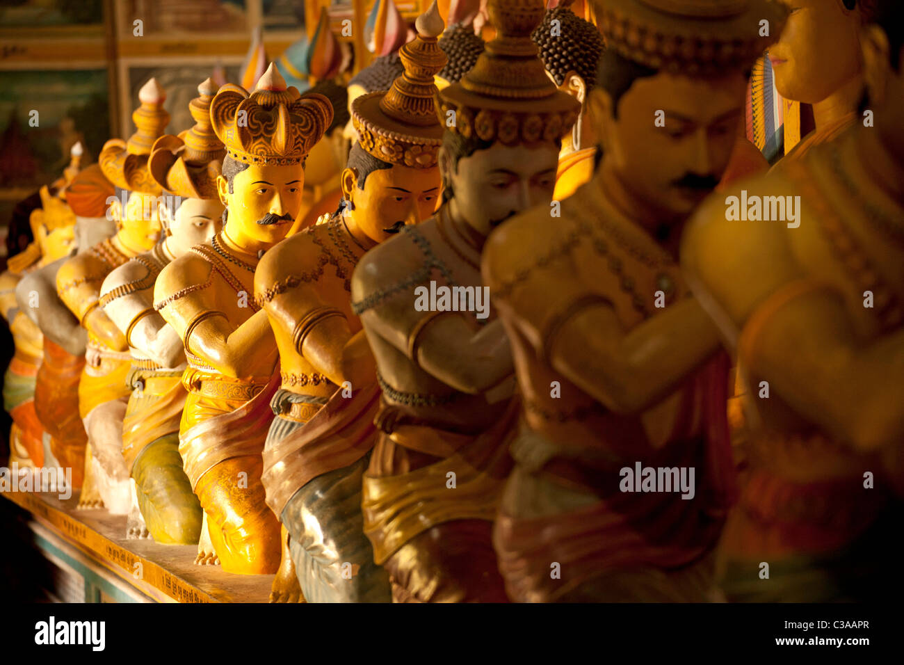 statues of Buddha and a row of his worshippers at Wewurukannala Vihara Temple near Dikwella, Pussalagoda, Sri Lanka, Walasgala Stock Photo