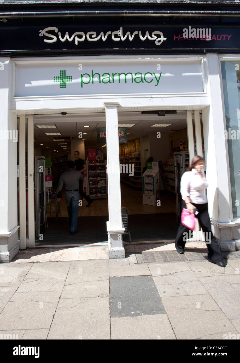 A person exits a Superdrug store. Stock Photo