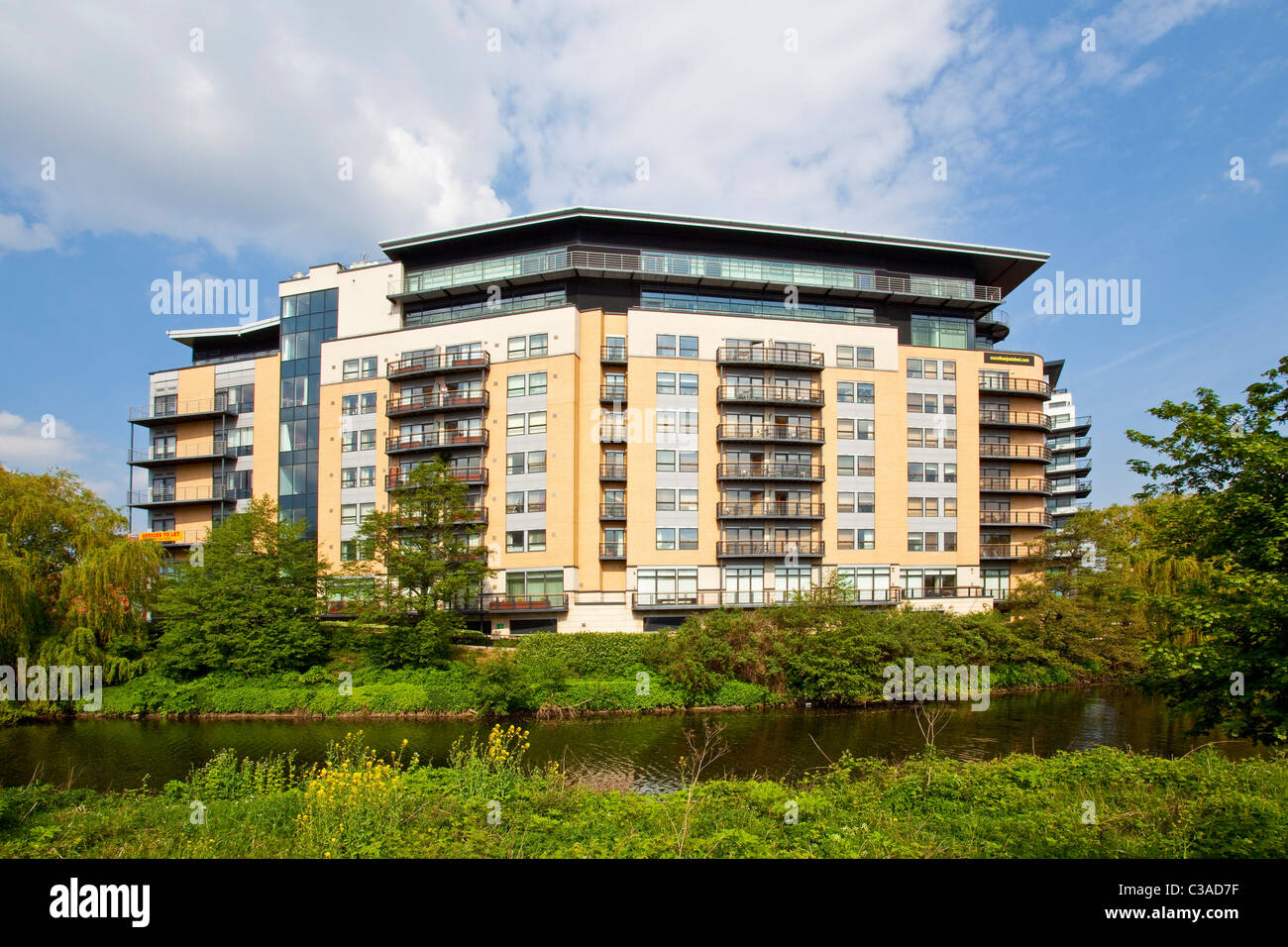 A modern appartment block at the side of the river Aire in Leeds city centre West Yorkshire UK Stock Photo