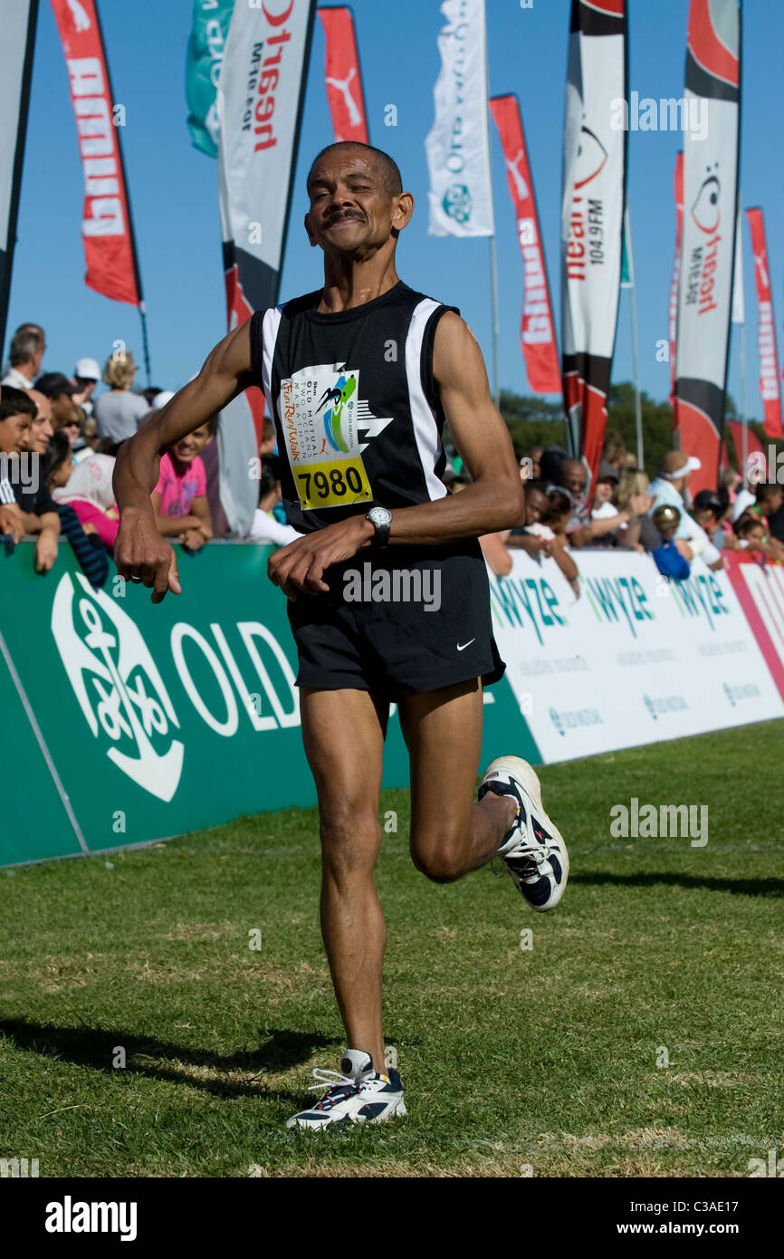 Runner with a disability finishes the 5km Fun Run of the Two Oceans Marathon, Cape Town, South Africa Stock Photo