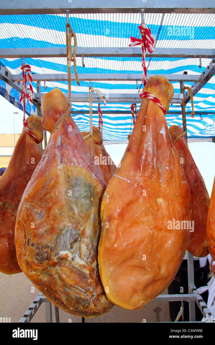 dried salted pork ham from Spain hanged on market Stock Photo