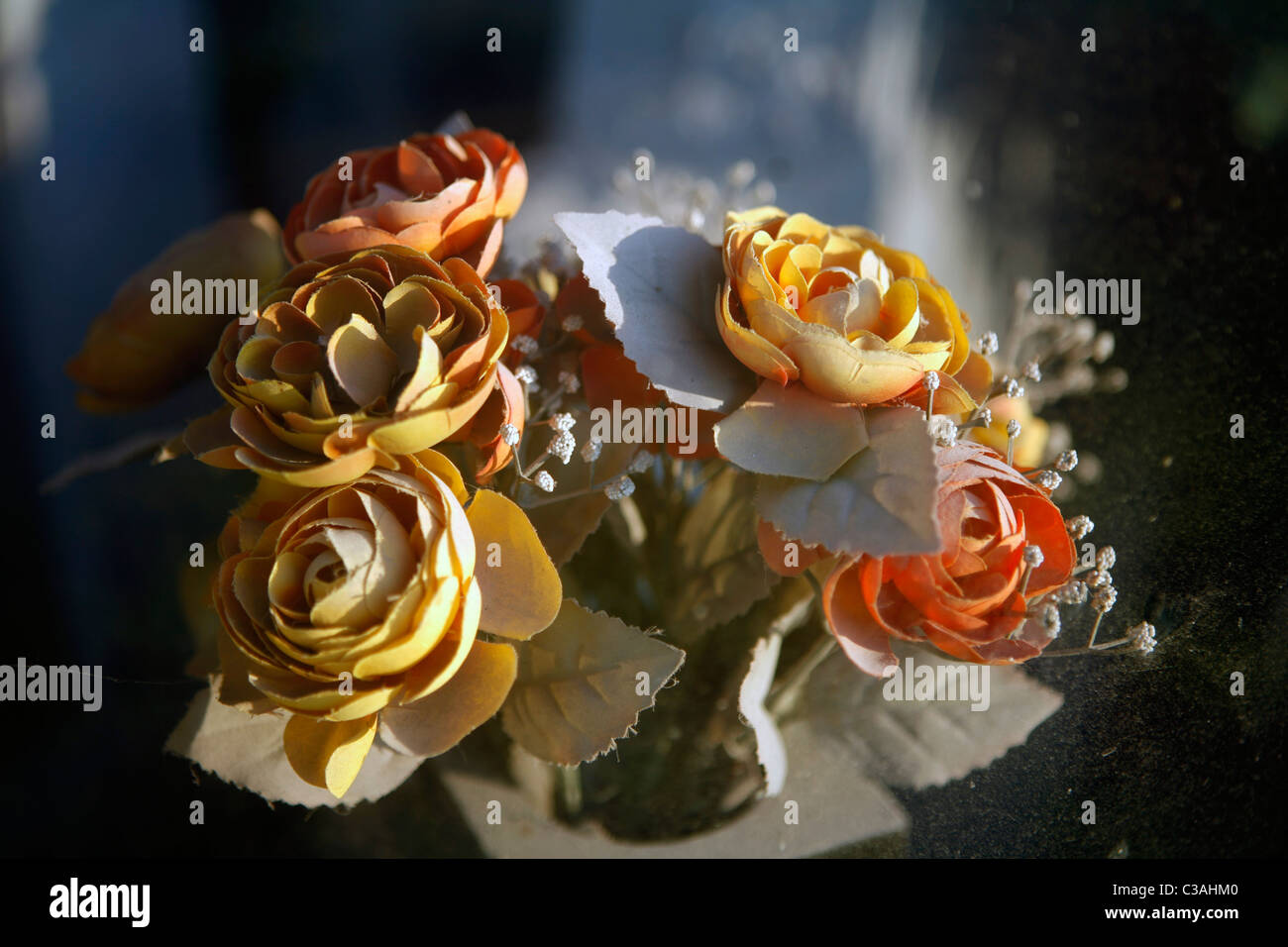 Plastic flowers sit fading in the sun in Cairo, Illinois a city at the