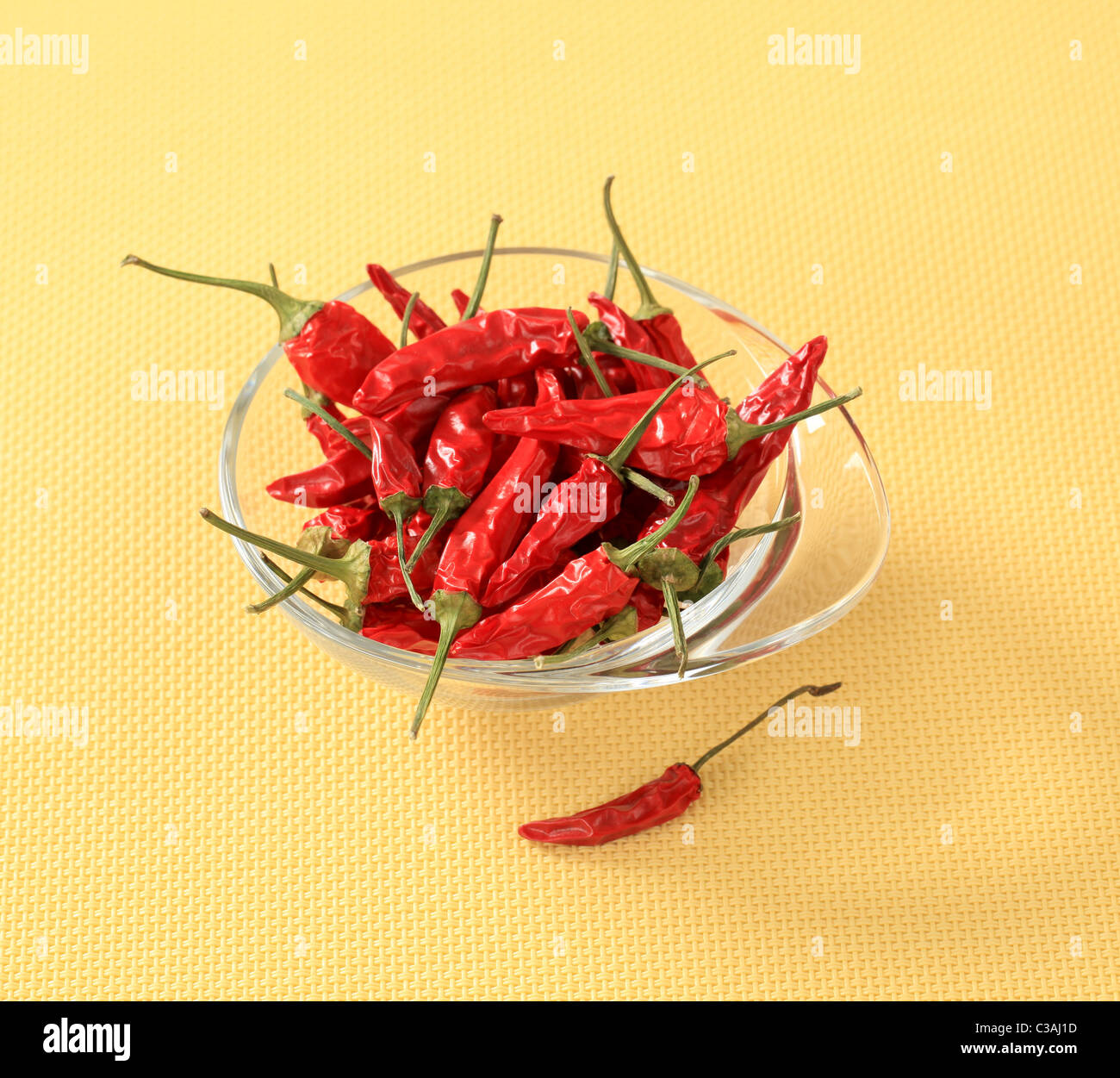 Dried red chili peppers in a glass bowl Stock Photo - Alamy