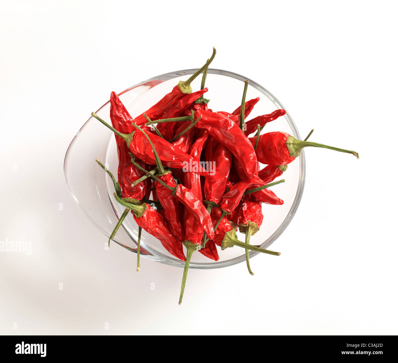 Dried red chili peppers in a glass bowl Stock Photo - Alamy