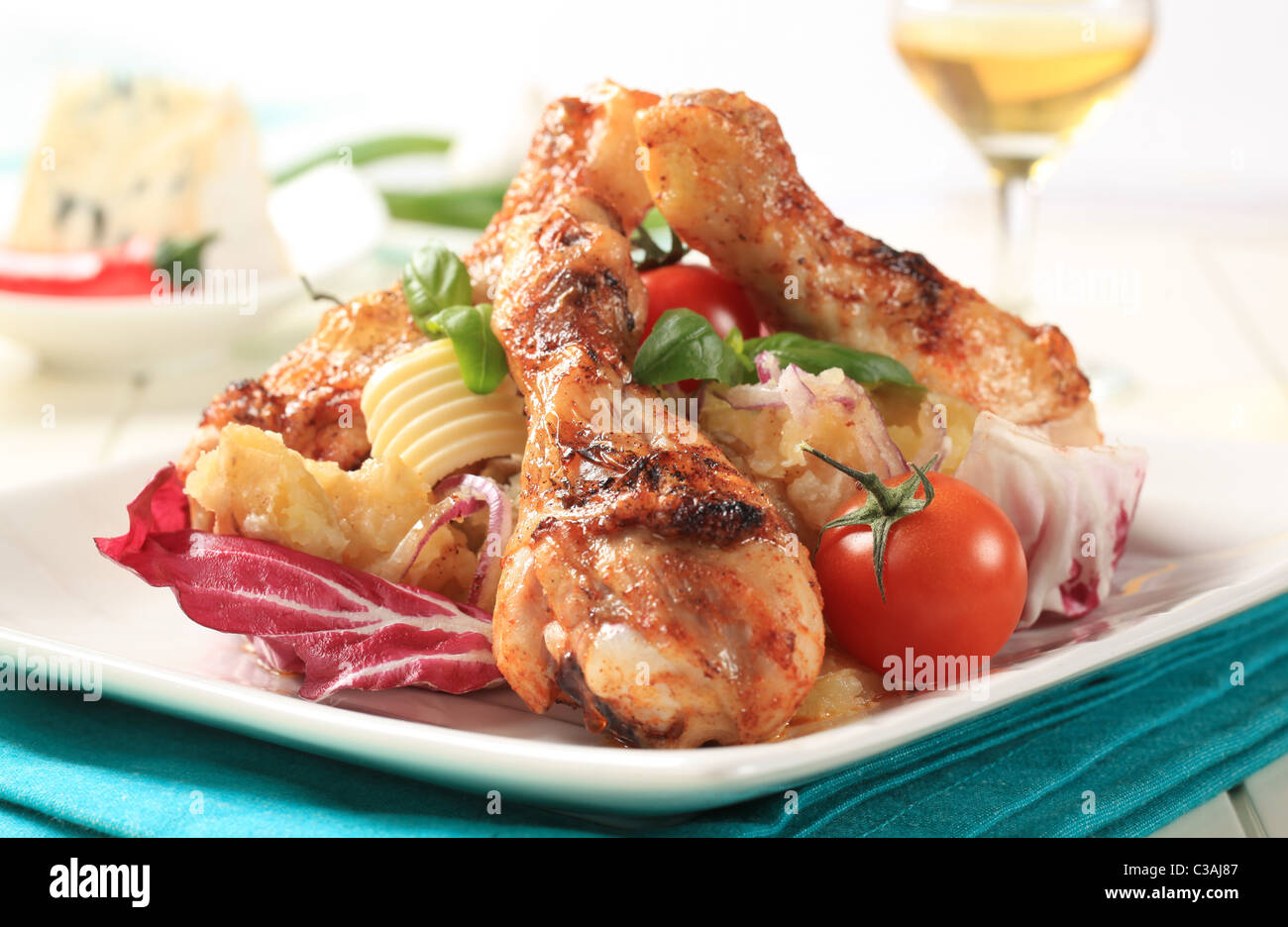 Roasted chicken drumsticks with crushed potatoes and lettuce Stock