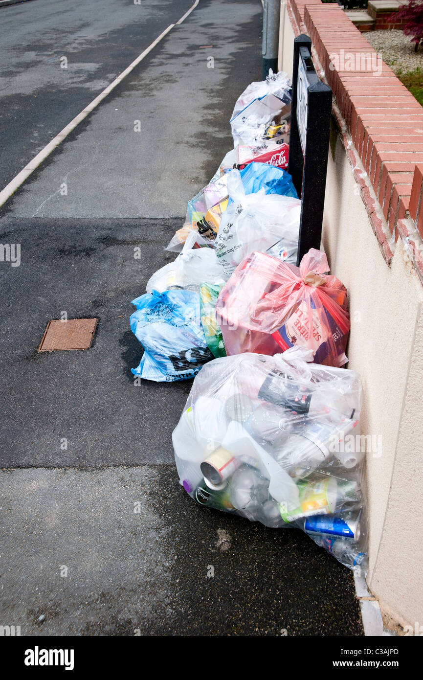 Recyclable household waste put out for kerbside collection. Householders sort the waste into eg Recyclable household waste put out for kerbside collection. Householders sort the waste into eg