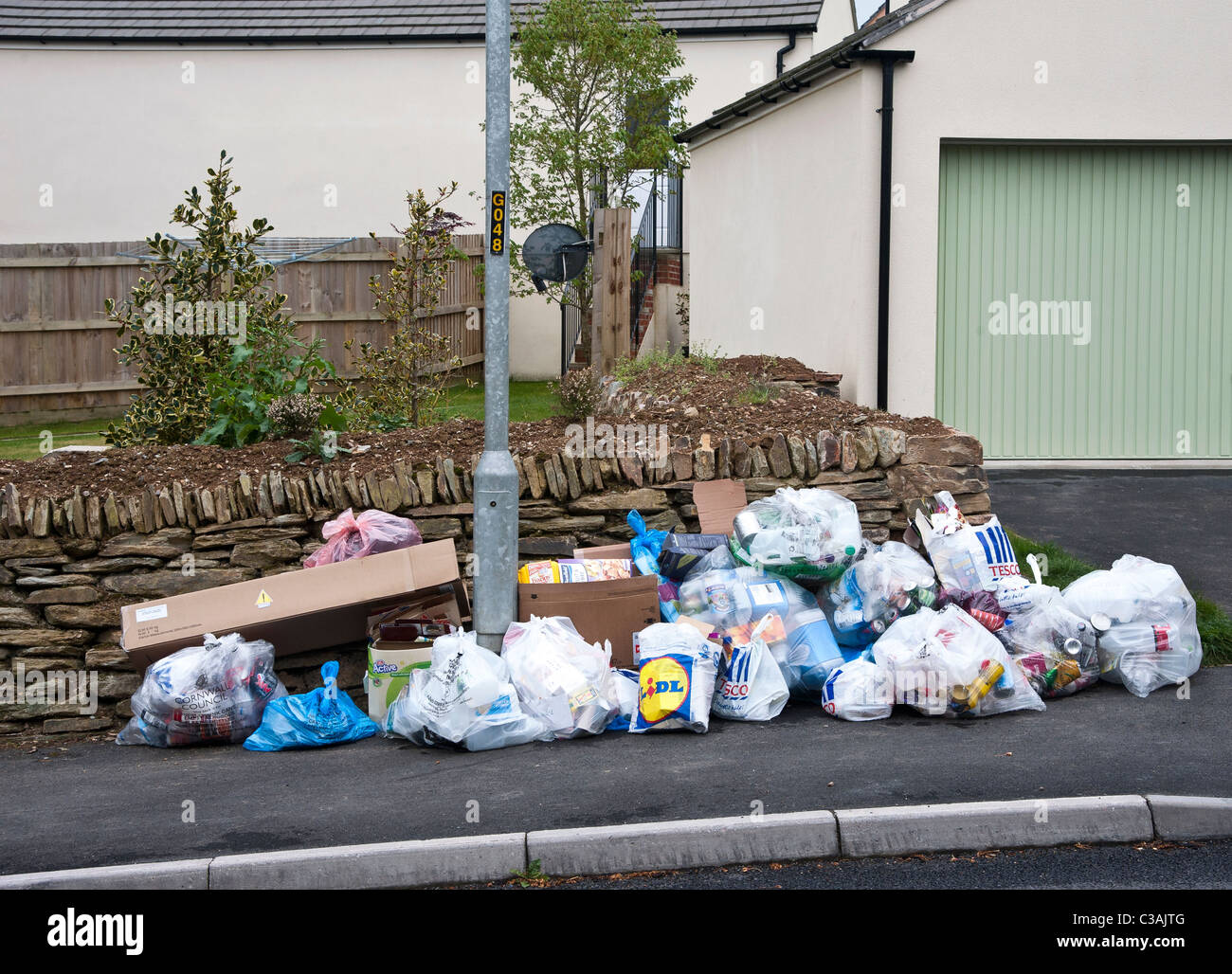 Recyclable household waste put out for kerbside collection. Householders sort the waste into eg Recyclable household waste put out for kerbside collection. Householders sort the waste into eg