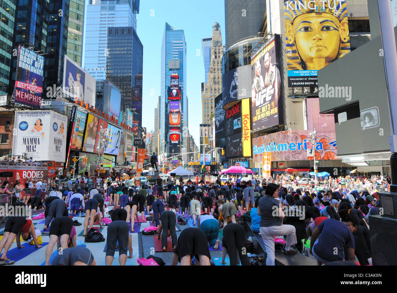 People participate in a yoga event in Times Square New York City. June 21, 2010. Stock Photo