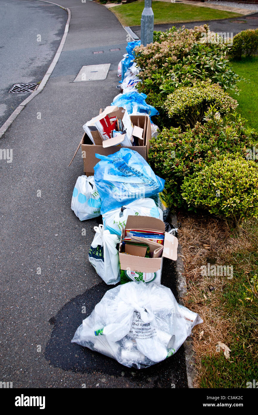 Recyclable household waste put out for kerbside collection. Householders sort the waste into eg Recyclable household waste put out for kerbside collection. Householders sort the waste into eg