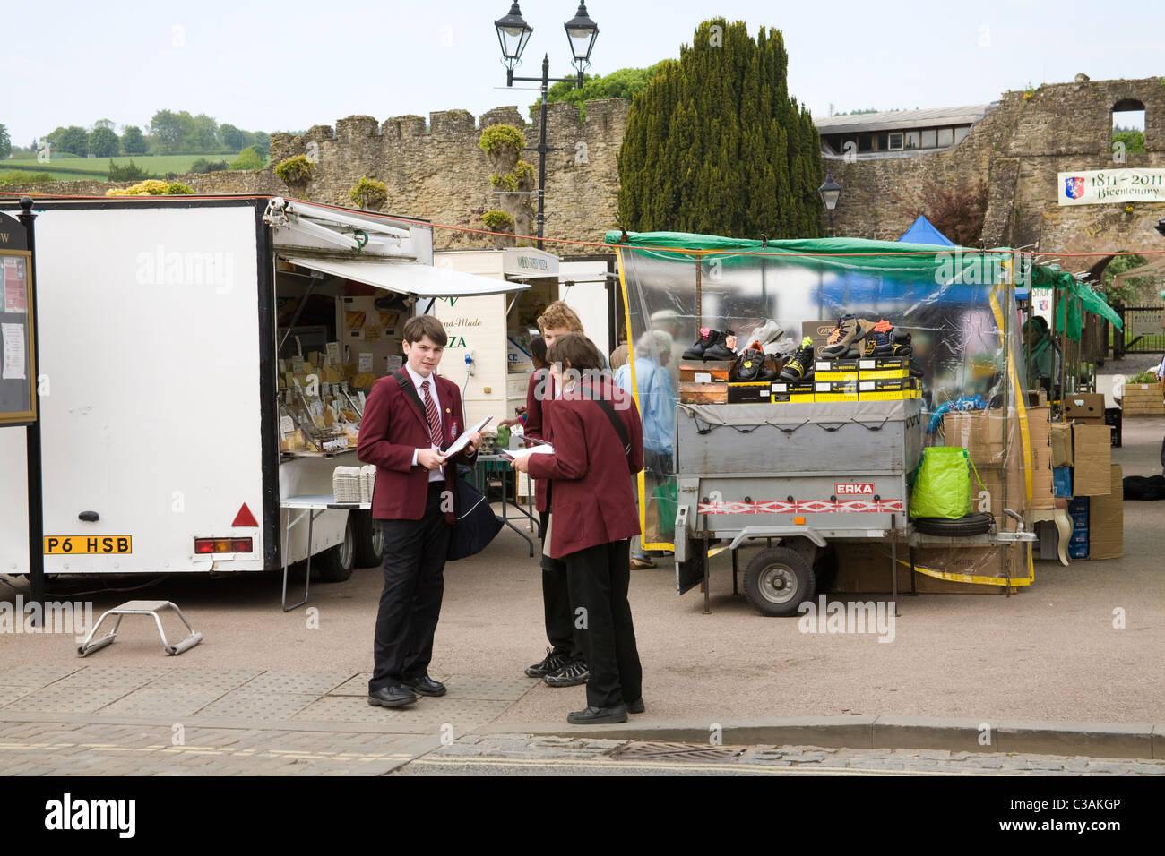 Ludlow Shropshire England UK Three boys in school uniform in the Market doing an educational project Stock Photo