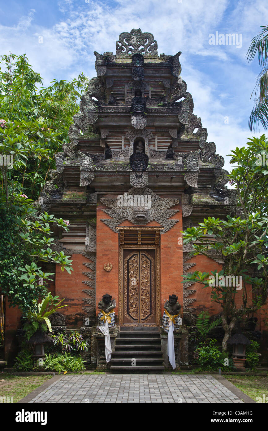 Ornate hand carved stone gate with Barong face of PURA DESA UBUD, the main Hindu temple of the town - UBUD, BALI Stock Photo