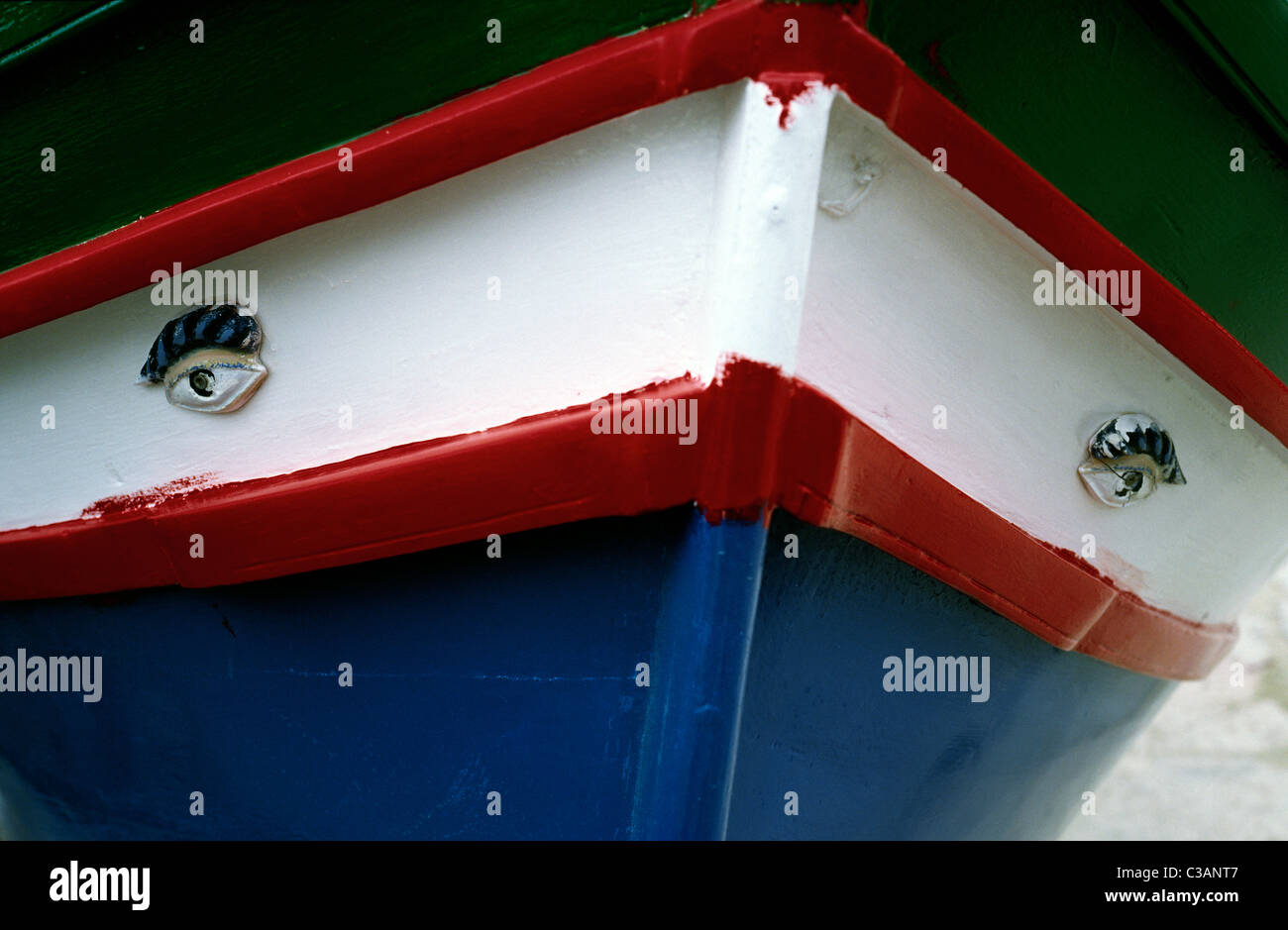 Evil eye on the bow of a traditional wooden Luzzu fishing boat on the Maltese island of Gozo. Stock Photo