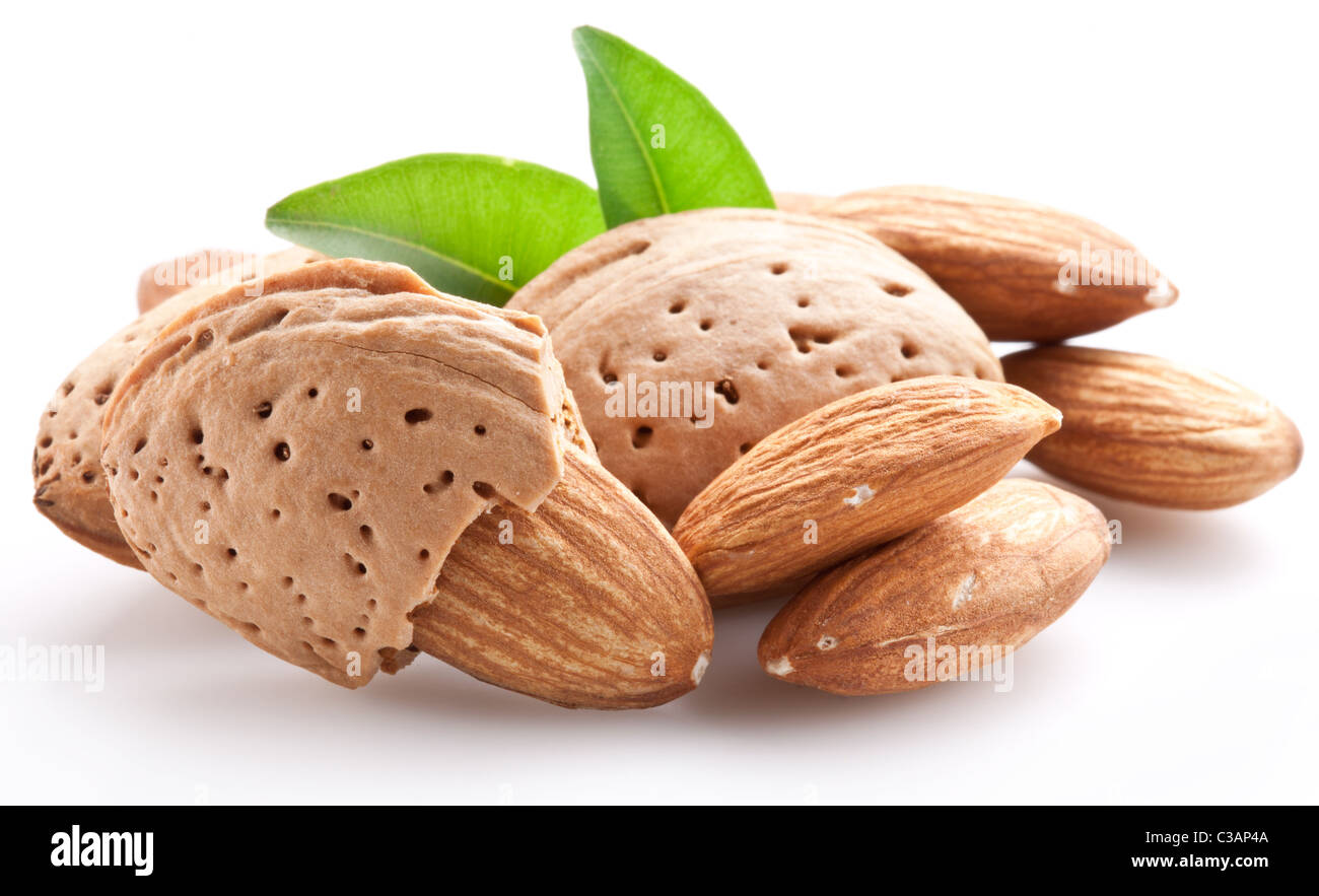 Group of almond nuts with leaves. Isolated on a white background. Stock Photo