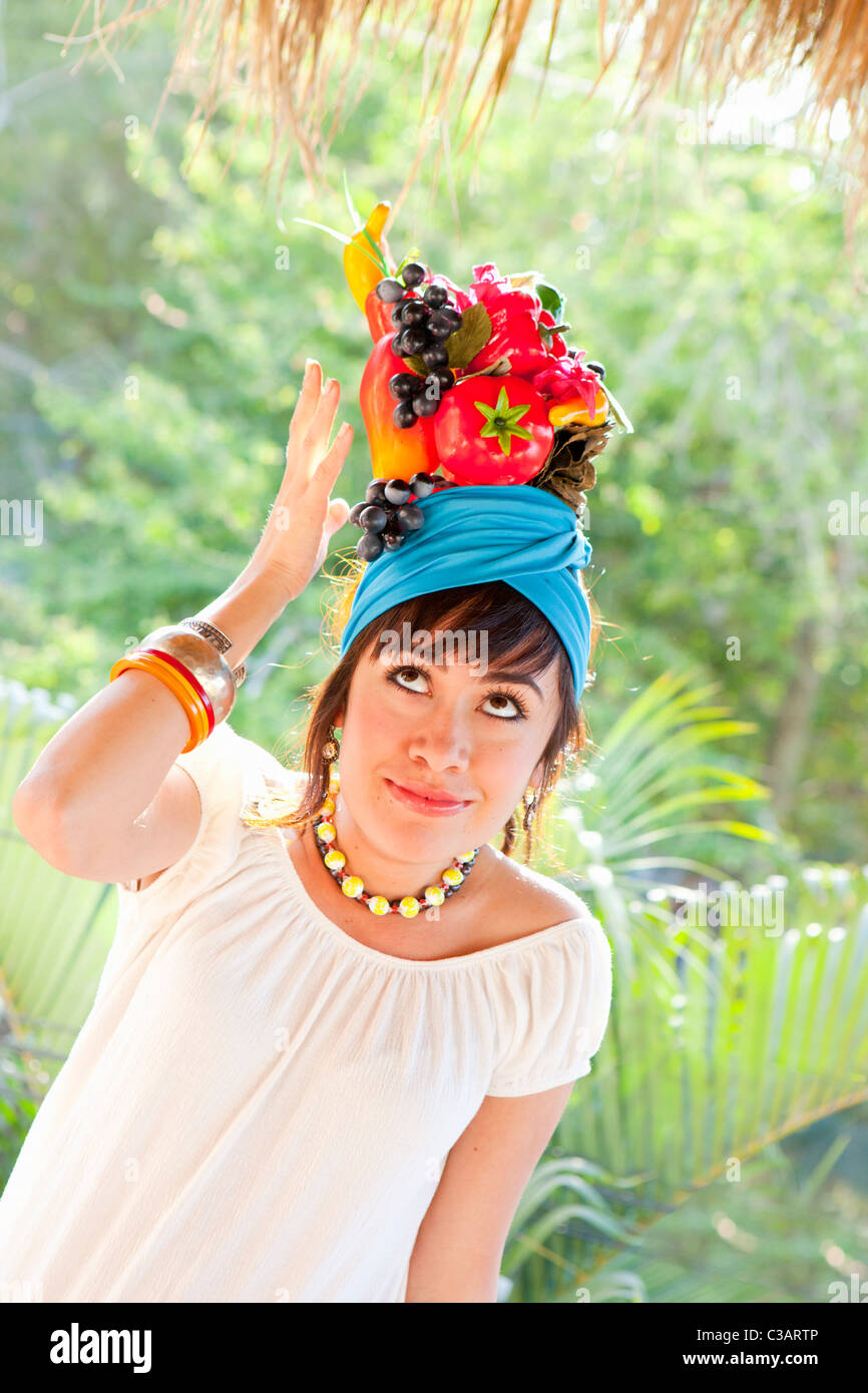 young woman wearing fruit hat Stock Photo Alamy