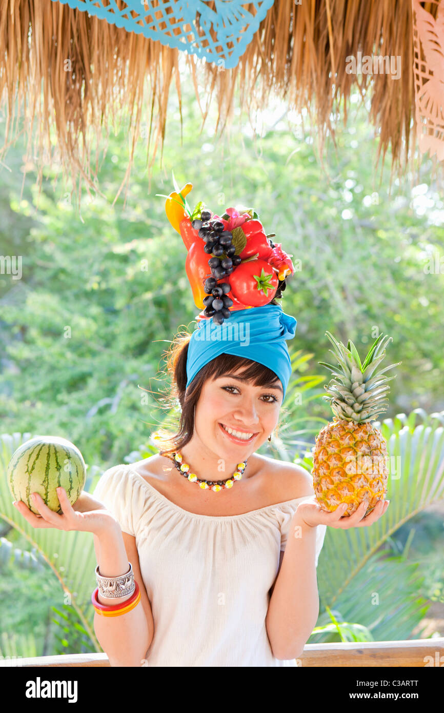 young woman wearing fruit hat Stock Photo Alamy