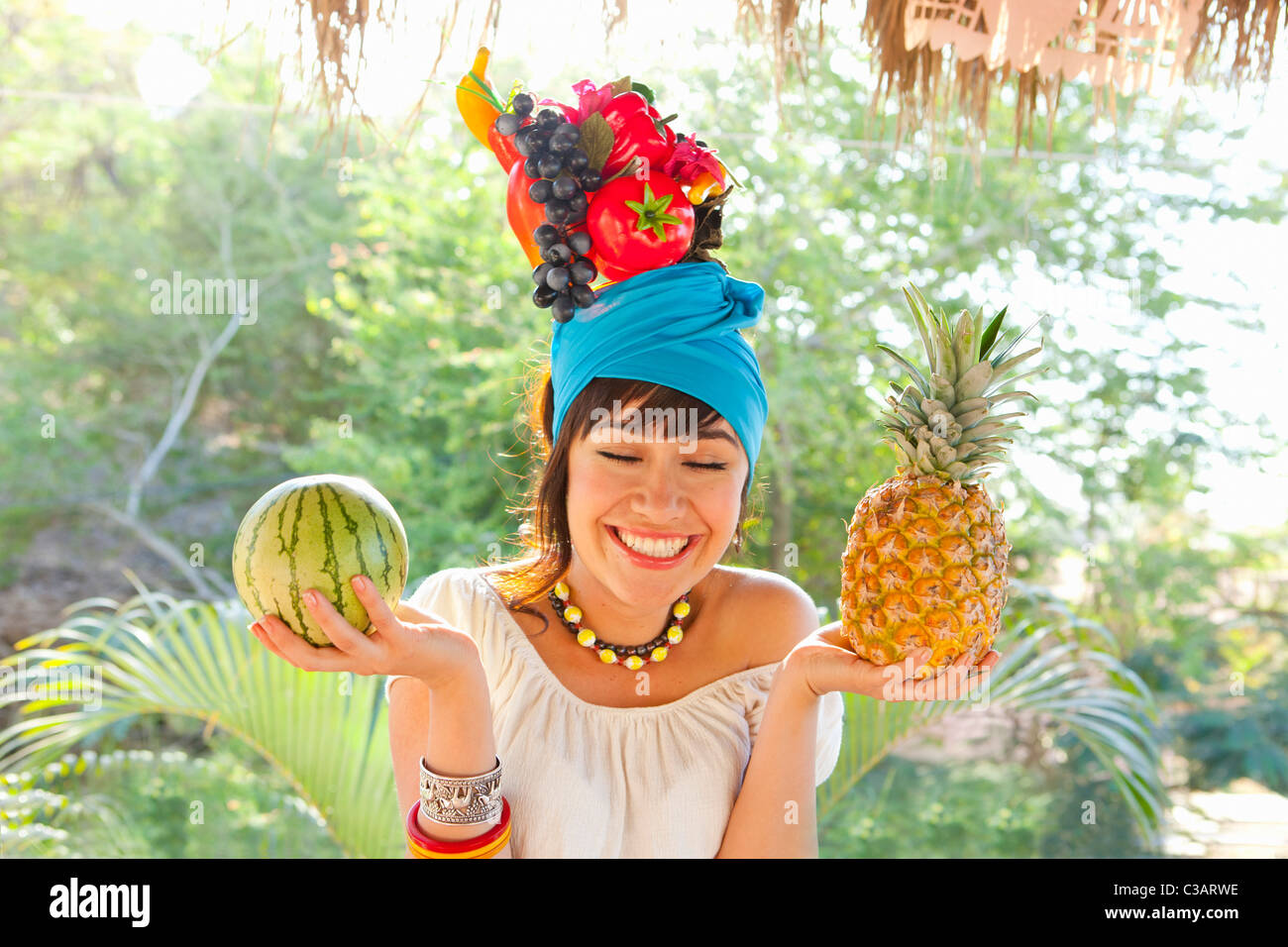 young woman wearing fruit hat Stock Photo Alamy