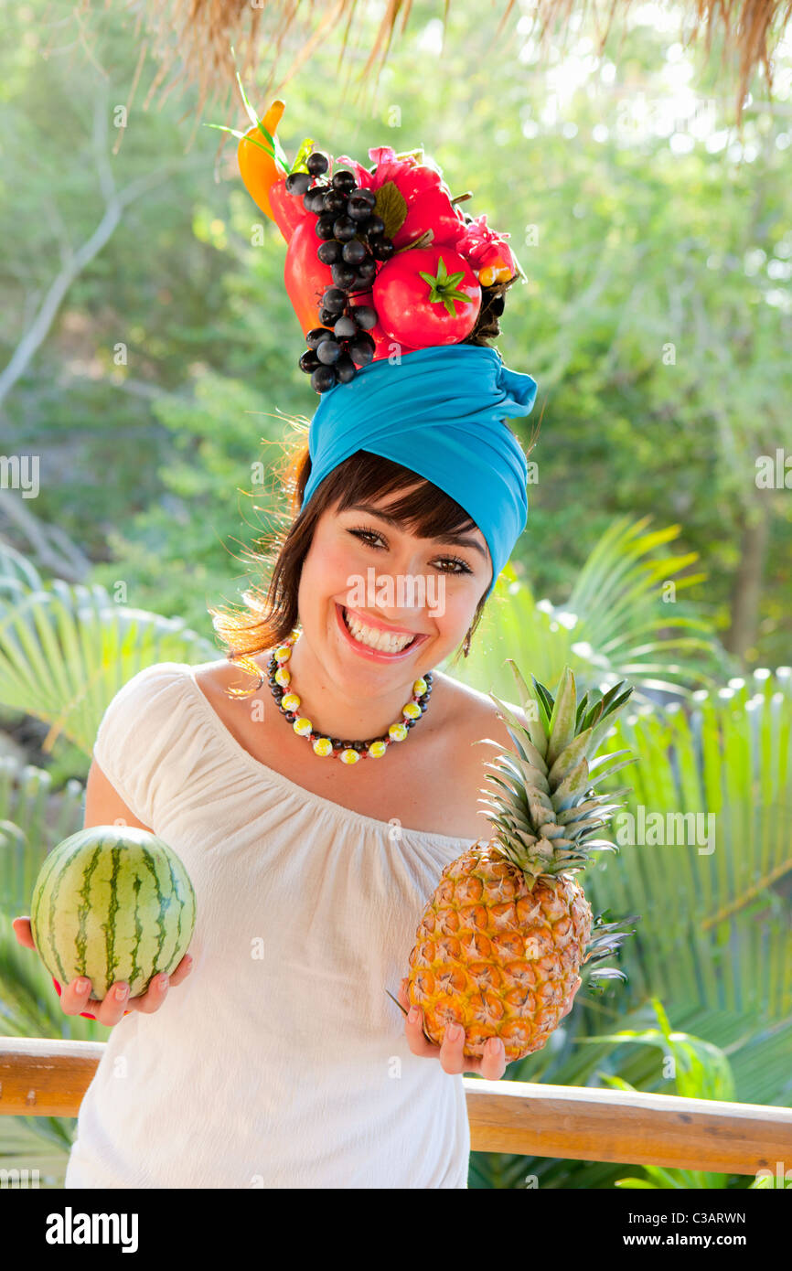 young woman wearing fruit hat Stock Photo Alamy