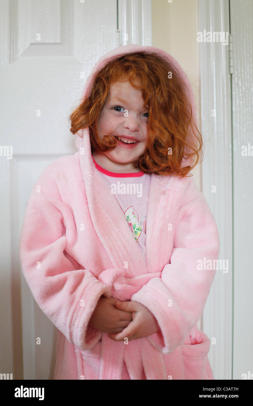 A Four Year Old Little Girl With Red Curly Hair Wearing A Dressing