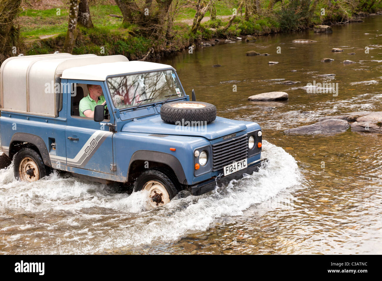 Landrover Defender fording the River Barle at Tarr Steps Exmoor Devon