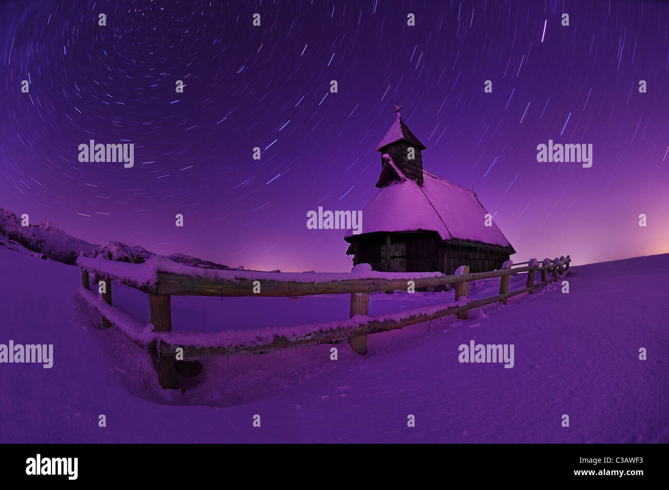 Wooden church in winter night. Velika Planina, Slovenia. Stock Photo