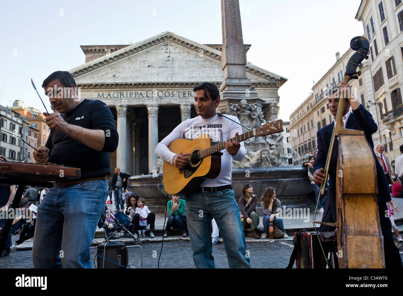 three men playing music in the street of Rome, in piazza della Rotonda, in front of the Pantheon, Rome, Italy Stock Photo