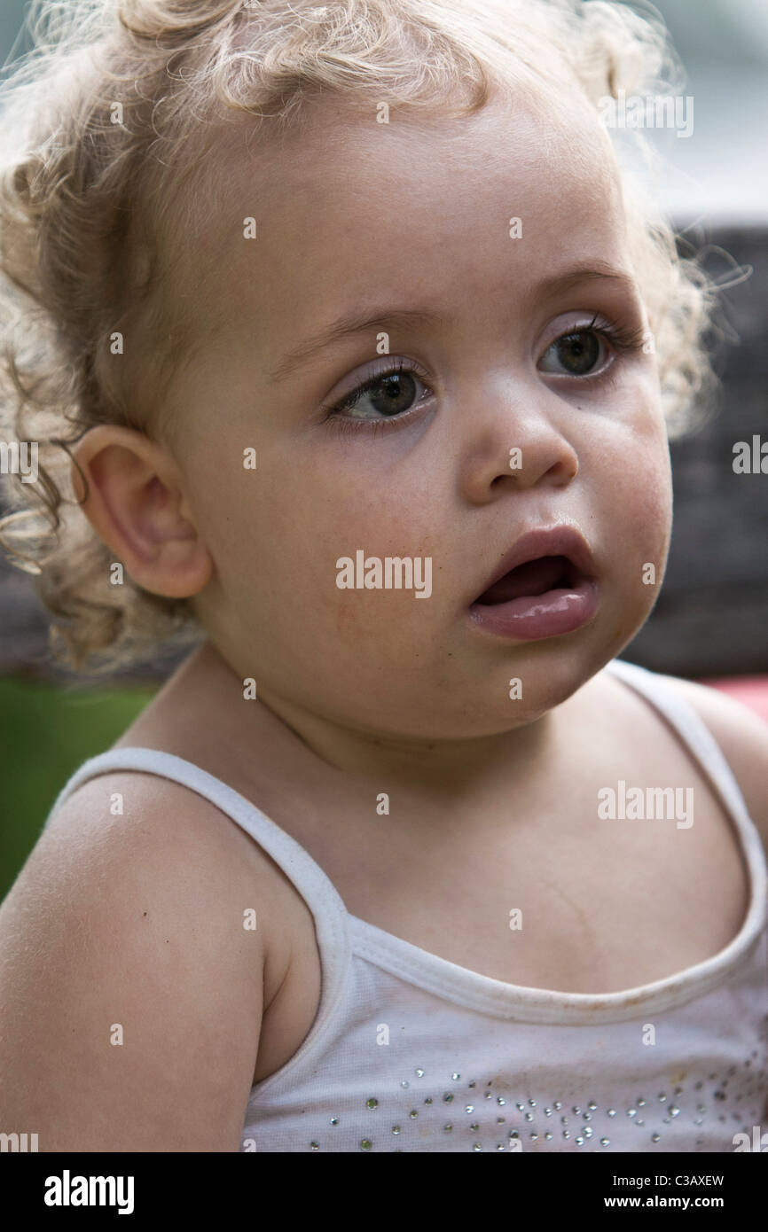 Blonde toddler girl wearing singlet Stock Photo