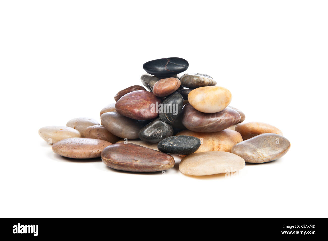 A pile of smooth, shiny river rocks on a white background. Stock Photo