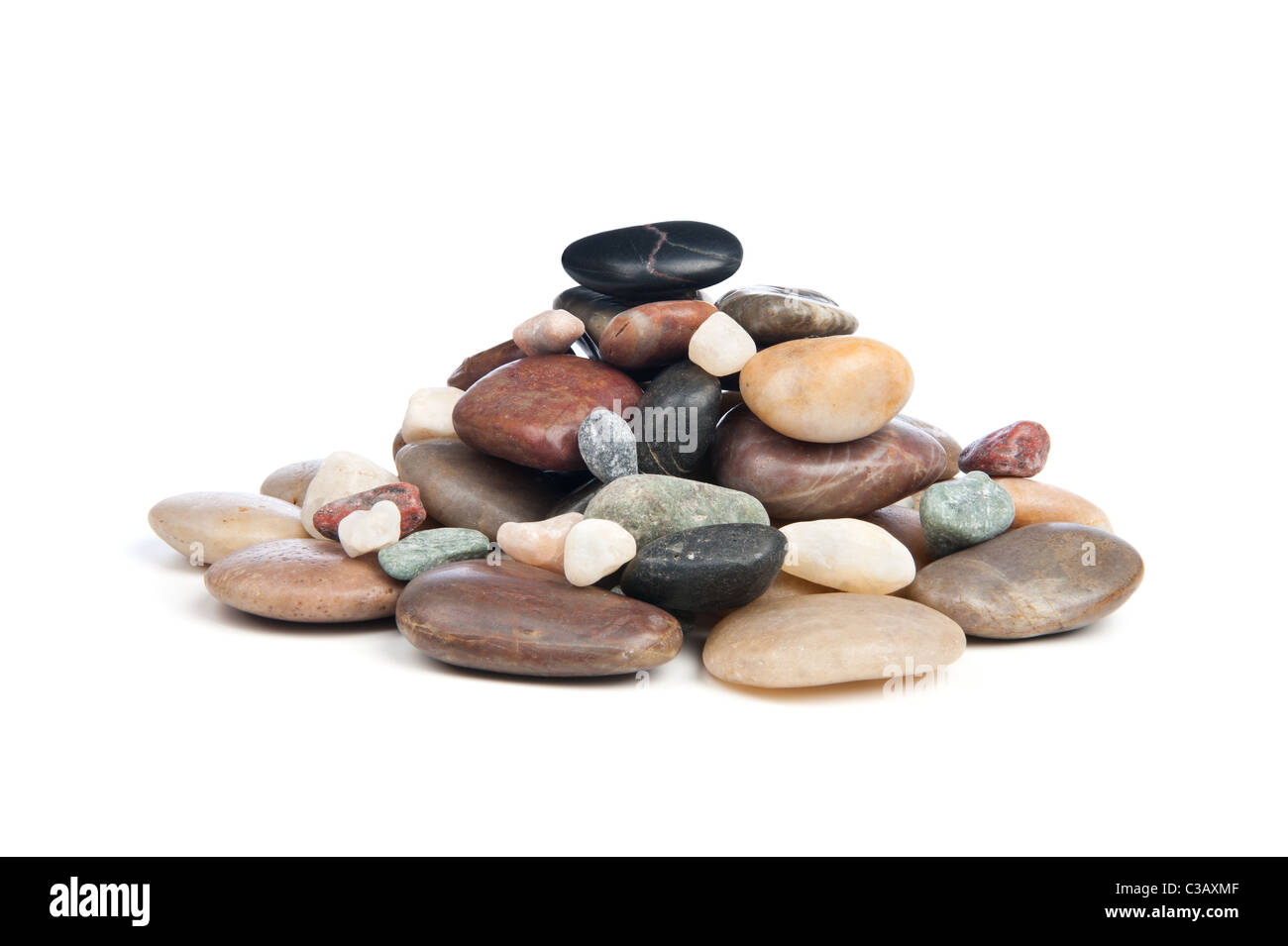 A pile of smooth, shiny river rocks on a white background. Stock Photo