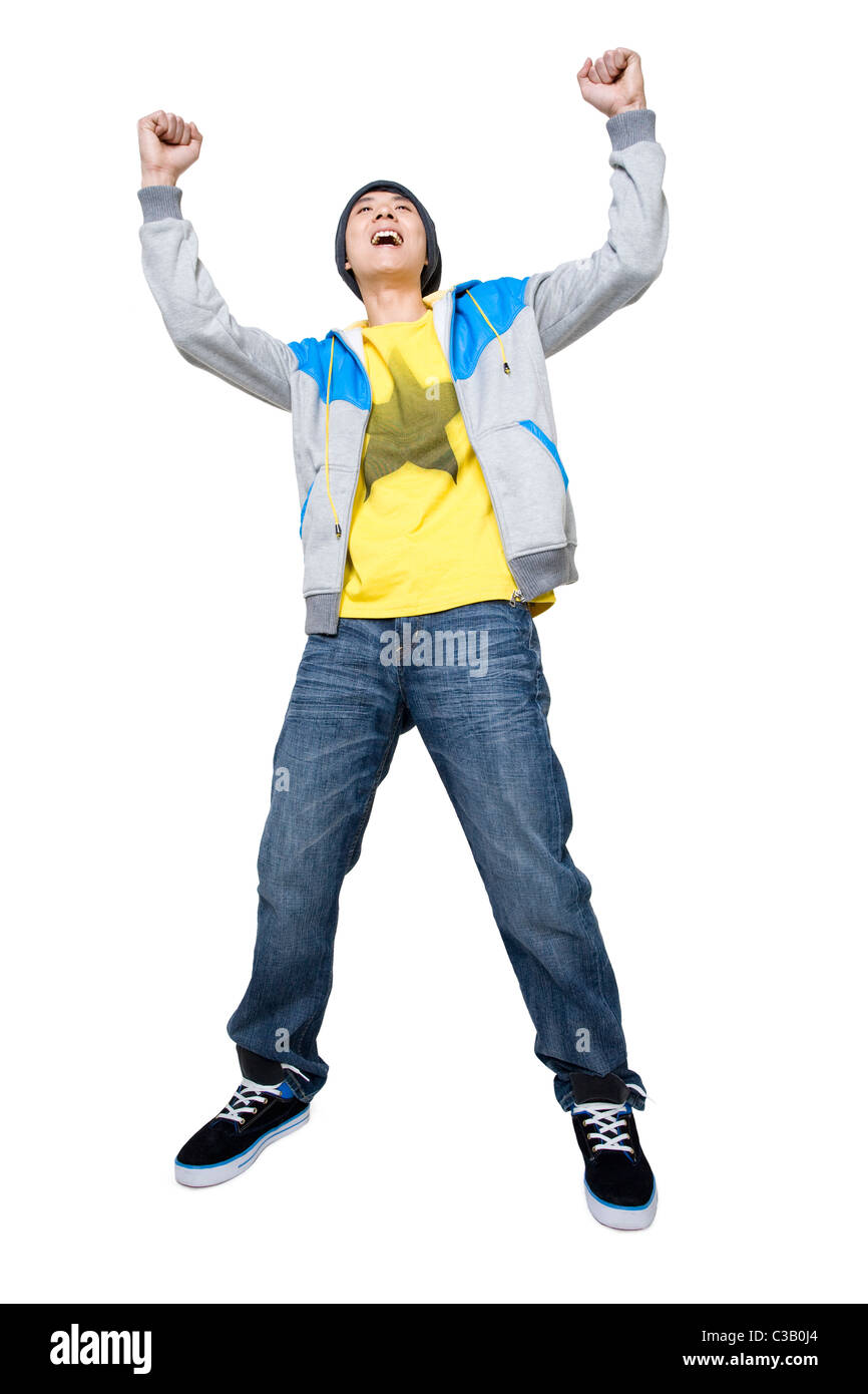 Smiling man with hands up in the air Stock Photo - Alamy