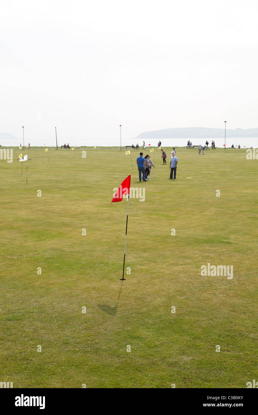 People playing pitch and putt on the Mackerston putting green in the