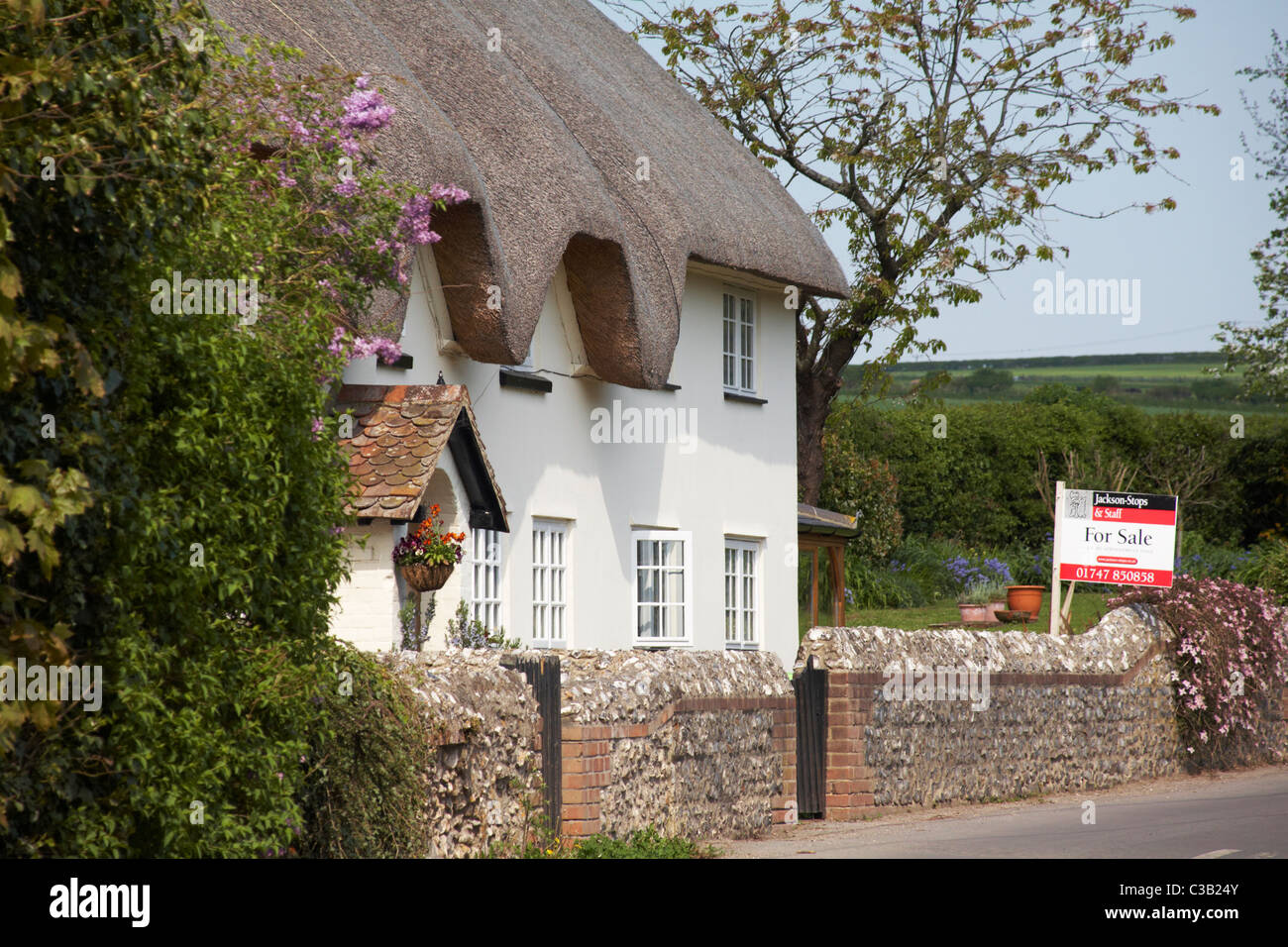 thatched cottage For Sale at Tarrant Monkton, Dorset in April Stock