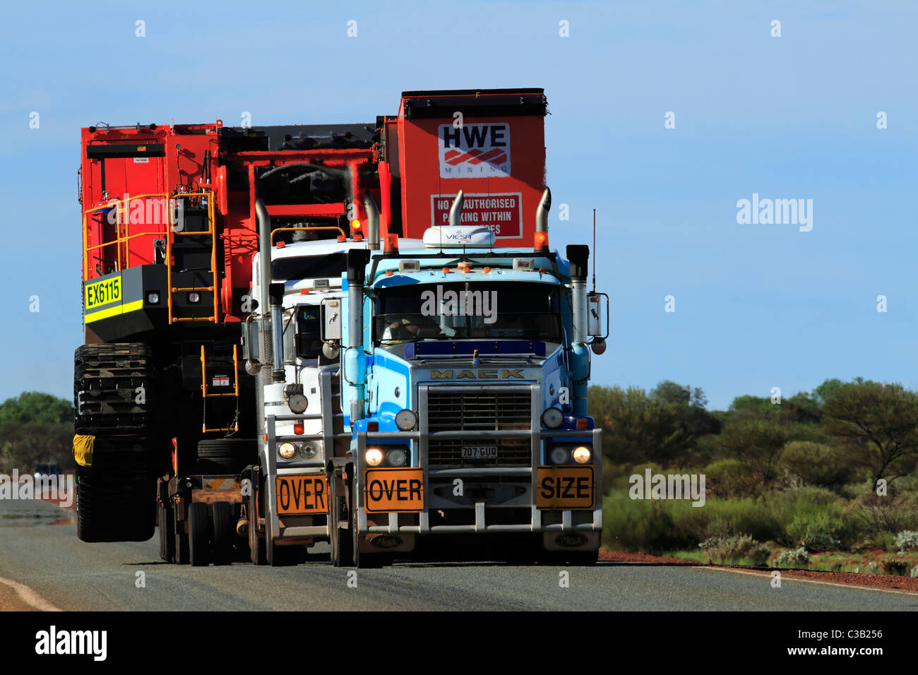 Heavy mine machinery being transported by road train trucks, Pilbara Northwest Australia Stock Photo