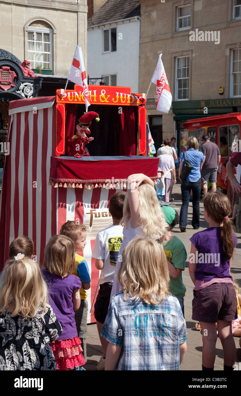 Children  watching a Punch and Judy show at a fair, Wallingford town, Oxfordshire, UK Stock Photo