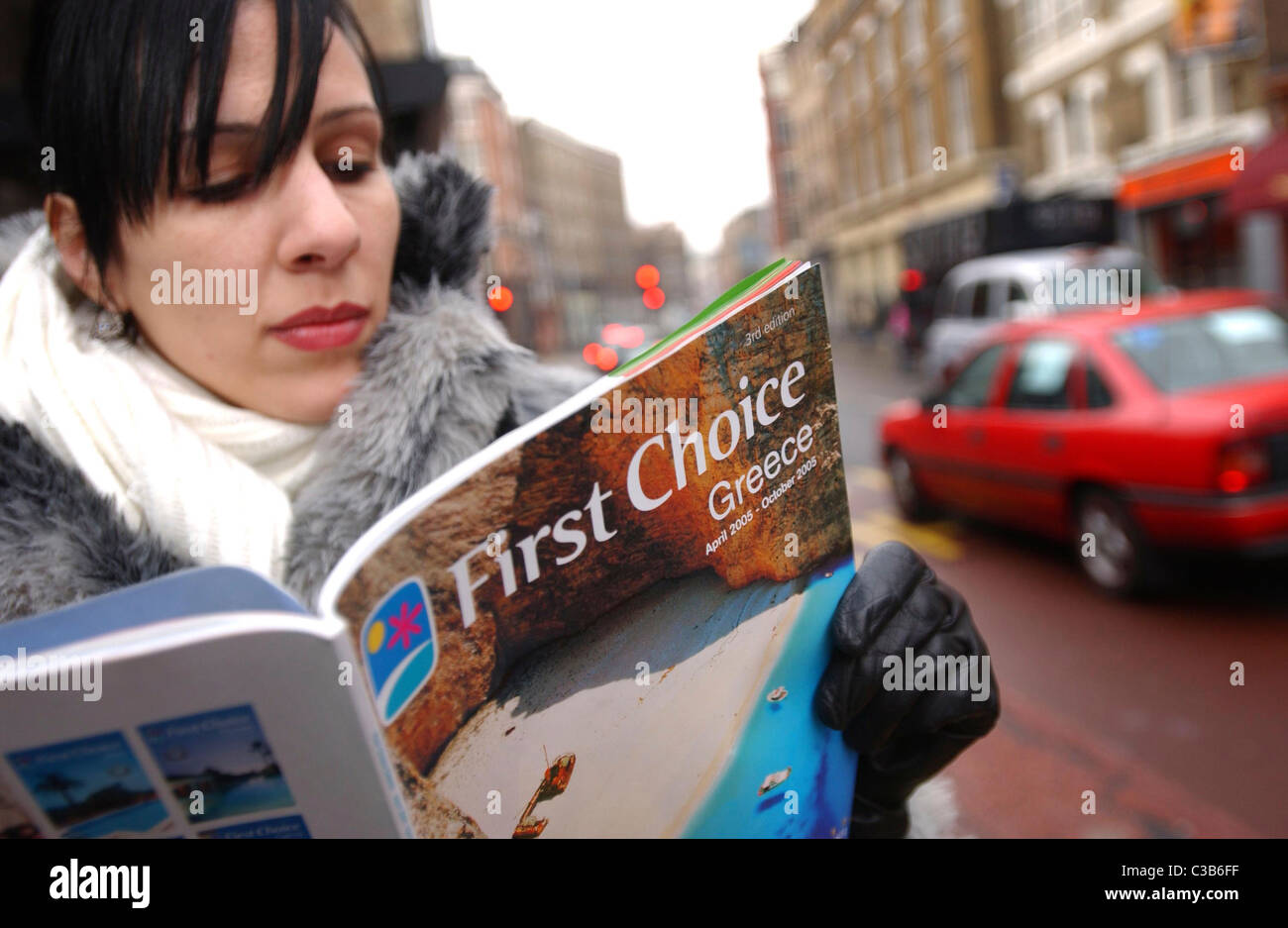 A woman browsing a First Choice holiday brochure. Stock Photo