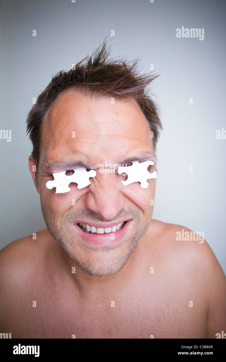 portrait of a man with jigsaw puzzle pieces Stock Photo