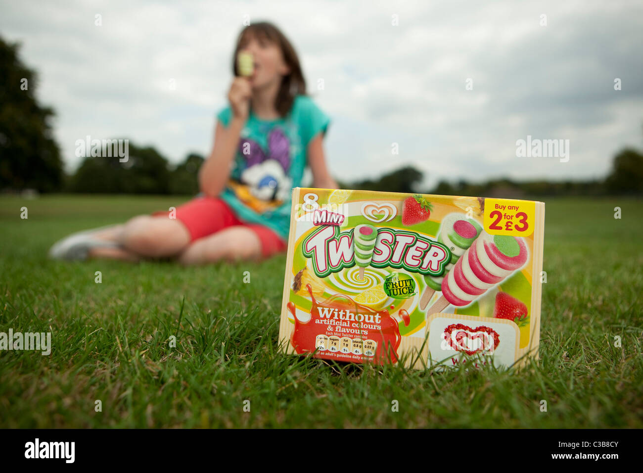 A young girl enjoys a Walls Twister ice-lolly, a Unilever brand. Stock Photo