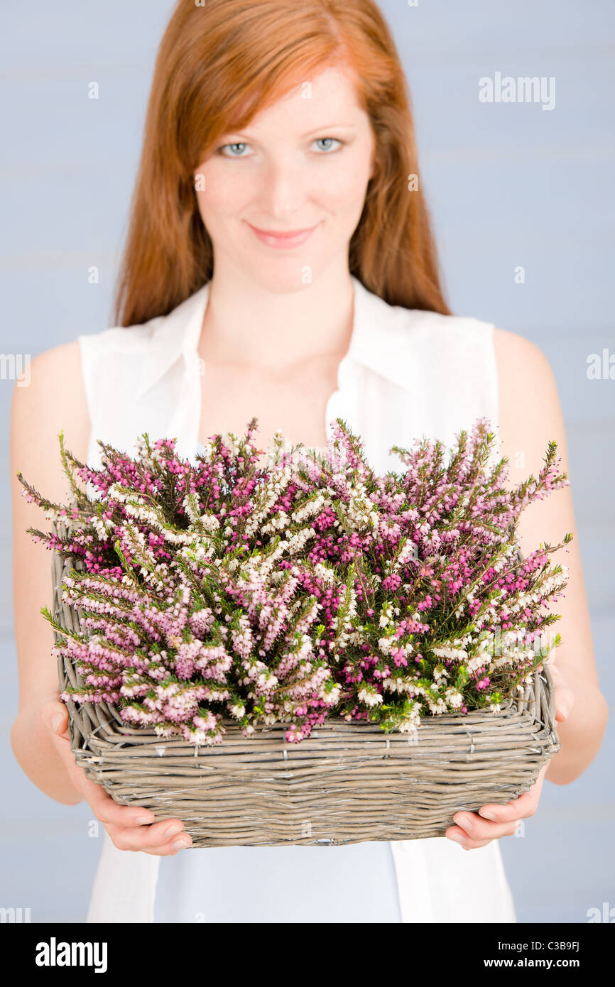 Summer portrait of redhead woman hold basket with flowers Stock Photo ...