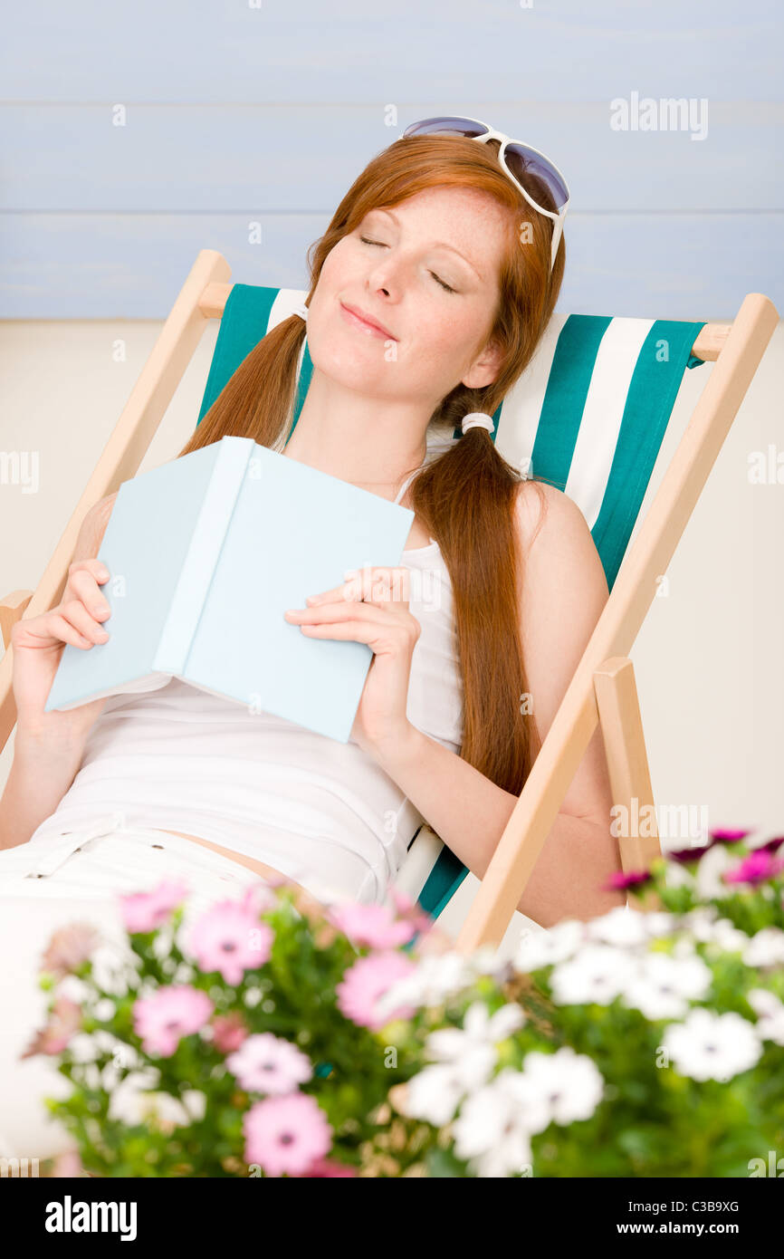 Summer terrace red hair woman relax in deckchair garden Stock Photo - Alamy
